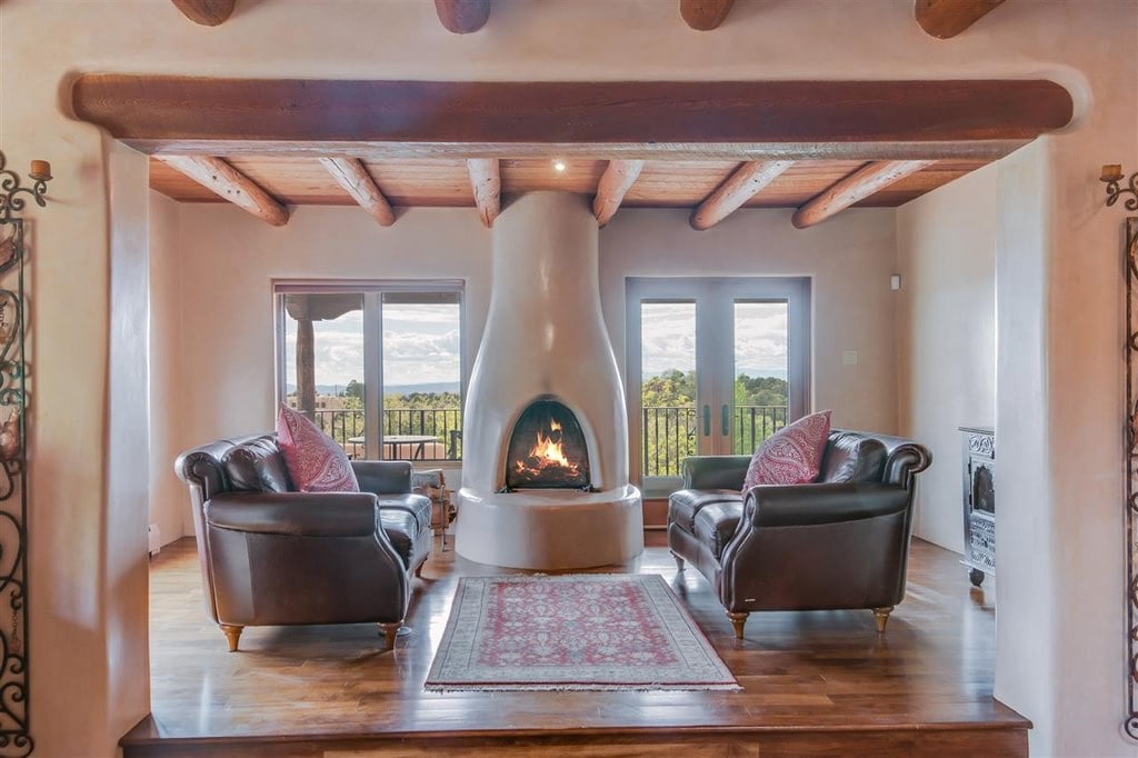 This is a Southwestern interior with fireplace and wood-beamed ceilings.