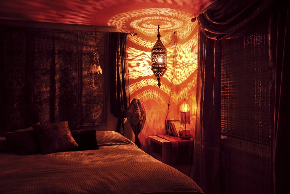 This is a close look at a Bohemian bedroom with awesome lighting.