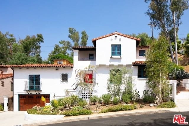 Spanish Colonial Revival Home with Wood Beam Ceilings