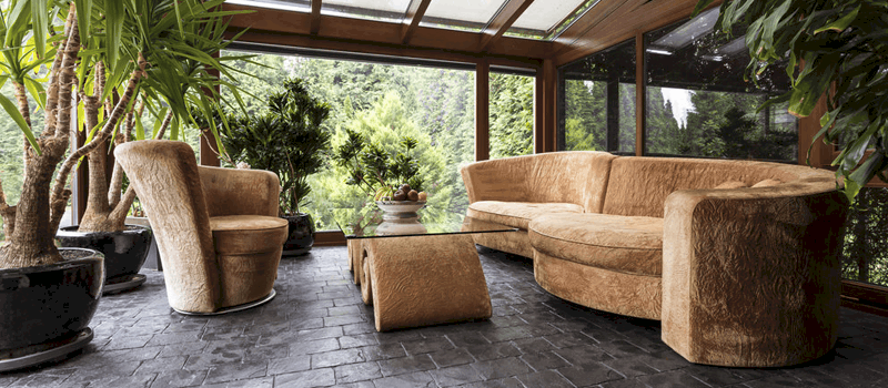 Sunroom and Conservatory room with beige sofa and graphite floor
